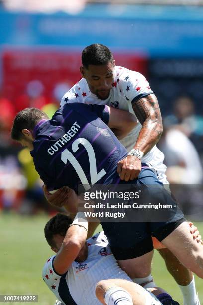 Jack Cuthbert of Scotland is tackled by Martin Iosefo and Stephen Tomasin of the United States during their match on day three of the Rugby World Cup...