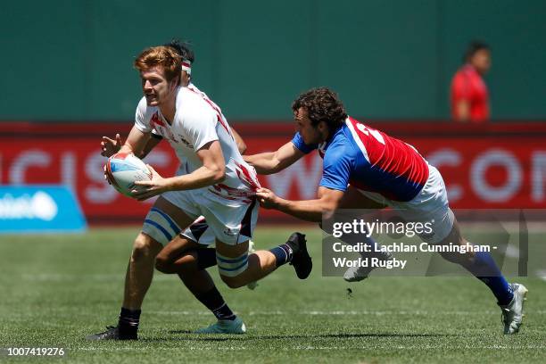 Liam Herbert of Hong Kong is tackled by Pedro Verschae of Chile during day three of the Rugby World Cup Sevens at AT&T Park on July 22, 2018 in San...