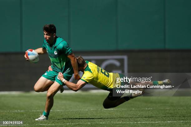 Jimmy O'Brien of Ireland is tackled by John Porch of Australia during day three of the Rugby World Cup Sevens at AT&T Park on July 22, 2018 in San...