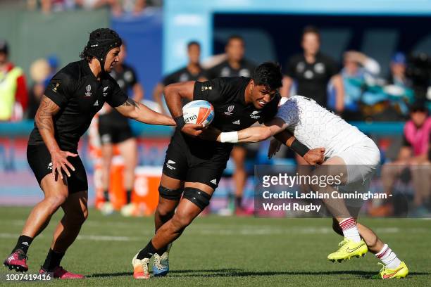 Dylan Collier of New Zealand is tackled by Alex Davis of England during the Championship final match on day three of the Rugby World Cup Sevens at...