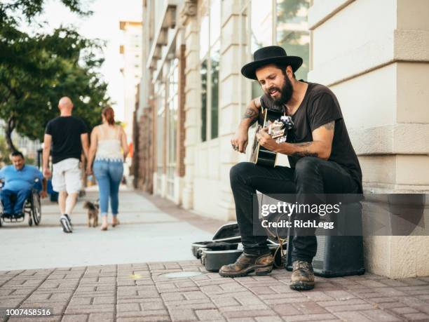 busking street musician - street musician stock pictures, royalty-free photos & images