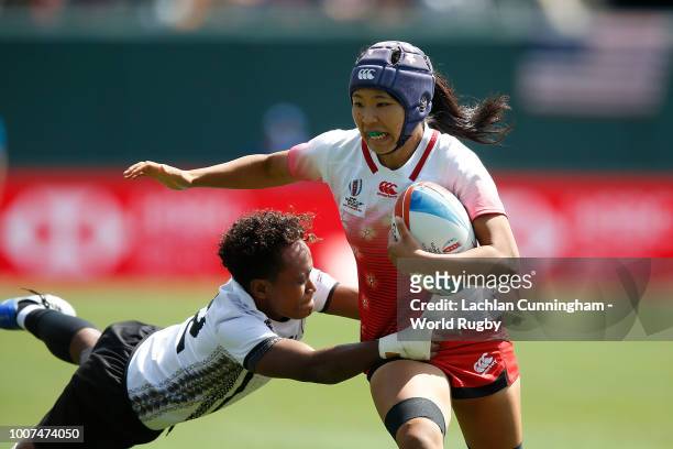 Sayaka Suzuki of Japan is tackled by Tima Ravisa of Fiji during day two of the Rugby World Cup Sevens at AT&T Park on July 21, 2018 in San Francisco,...