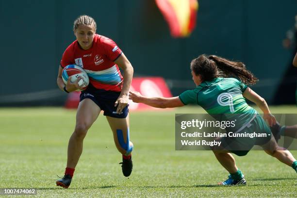 Marina Kukina of Russia evades a tackle by Lucy Mulhall of Ireland during day two of the Rugby World Cup Sevens at AT&T Park on July 21, 2018 in San...