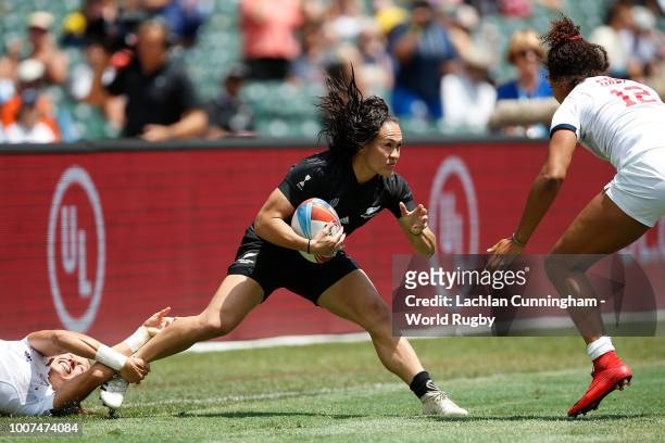 Portia Woodman of New Zealand is tackled by Abby Gustaitis and Jordan Gray of the United States during day two of the Rugby World Cup Sevens at AT&T...