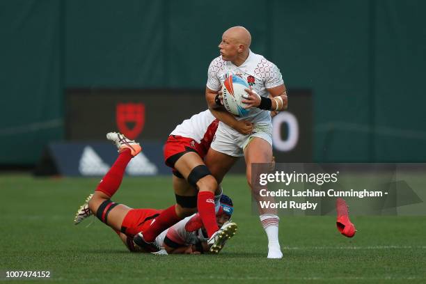 Heather Fisher of England is tackled by Iroha Nagata and Yukari Tateyama of Japan during day two of the Rugby World Cup Sevens at AT&T Park on July...