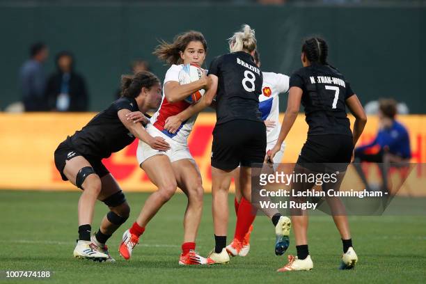 Coralie Bertrand of France is tackled by Kelly Brazier and Ruby Tui of New Zealand during the Championship final match on day two of the Rugby World...