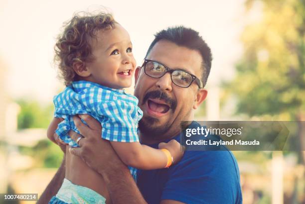 father holding smiling toddler son - man wearing diaper stock pictures, royalty-free photos & images