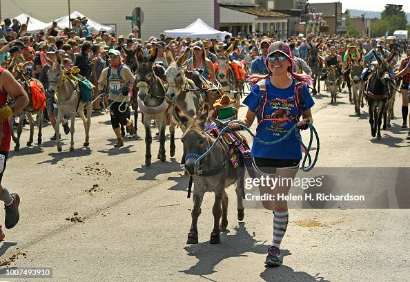 Racers and their donkeys take off up Front Street as they begin the ...