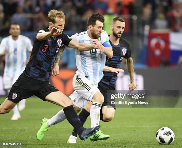 Lionel Messi of Argentina is challenged by Ivan Strinic of Croatia during the second half of a World Cup group stage match in Nizhny Novgorod Russia,...