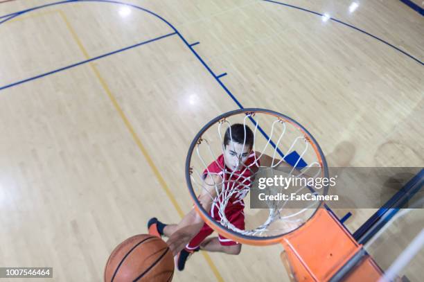 overhead view of high school basketball player leaping to the basket - high school basketball stock pictures, royalty-free photos & images