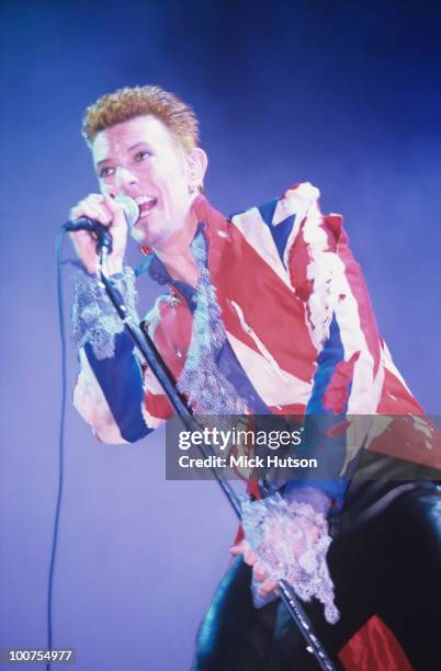 Singer David Bowie performs on stage, wearing a Union Jack jacket, at the Phoenix Festival held at Long Marston Airfield near Stratford-Upon Avon on...