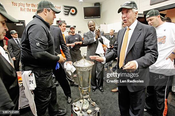 Harry Bricker equipment manager of the Philadelphia Flyers and Flyers Chairman Ed Snider celebrate with the Prince of Wales Trophy after defeating...