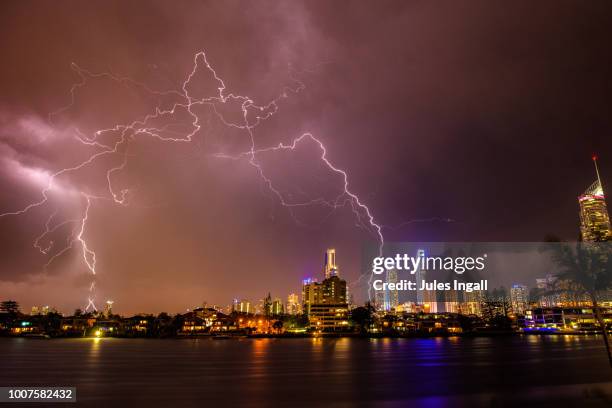 thunder storm and lightening with city skyline - queensland storm stock pictures, royalty-free photos & images