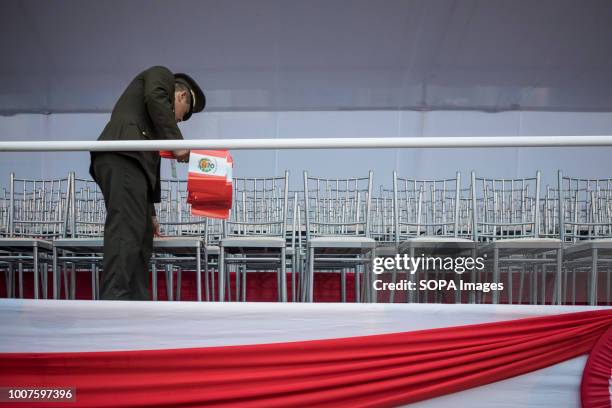 Police officers seen making arrangements before the start of the military parade. Members of Peru's armed forces, coastguard, search & rescue, and...