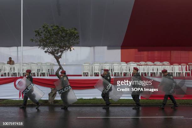 Police officers seen taking posts before the start of the military parade. Members of Peru's armed forces, coastguard, search & rescue, and police...