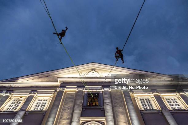 Acrobats walk on a line during the illusionist festival in Lublin, Poland on July 28, 2018.