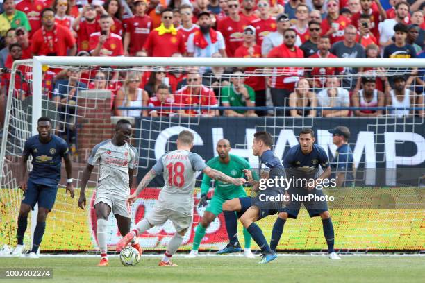 Alberto Moreno of Liverpool attempts to kick in a goal defended by Manchester goalie Lee Grand during an International Champions Cup match between...