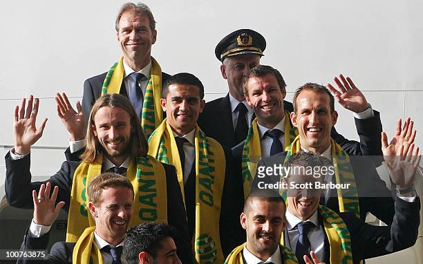 Members of the Socceroos including coach Pim Verbeek and captain Lucas Neill wave as they board their aeroplane during the Australian Socceroos...