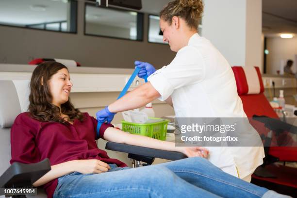 若い女性看護師による献血活動の準備を取得 - blood donation ストックフォトと画像