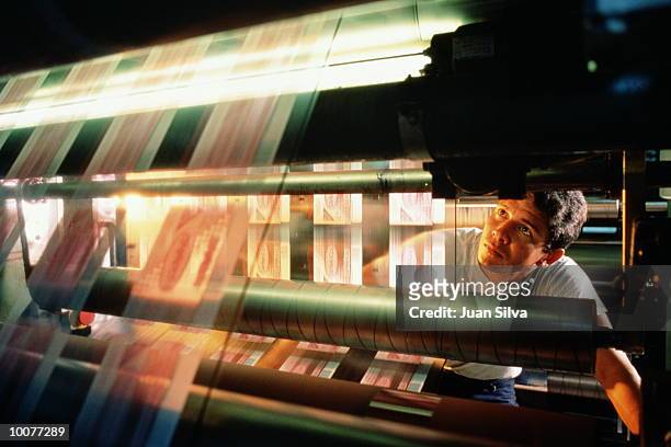 worker with flexography machine - drukkerij stockfoto's en -beelden