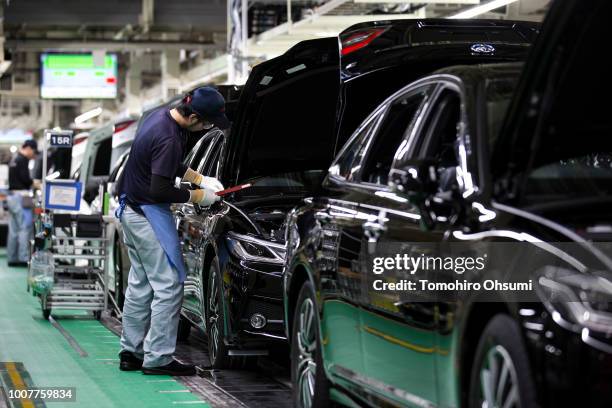 Worker assembles a Toyota Motor Corp Crown vehicle on the production line of the company's Motomachi factory on July 30, 2018 in Toyota, Japan....