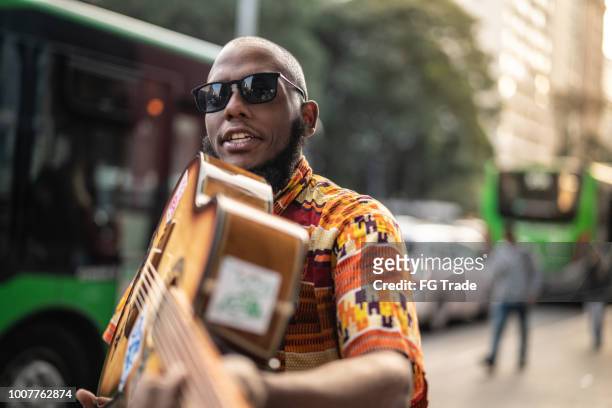 afro descent singer showing your guitar - male guitarist stock pictures, royalty-free photos & images