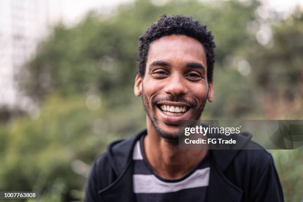 portrait of handsome latino african man - man laughing smiling stock pictures, royalty-free photos & images