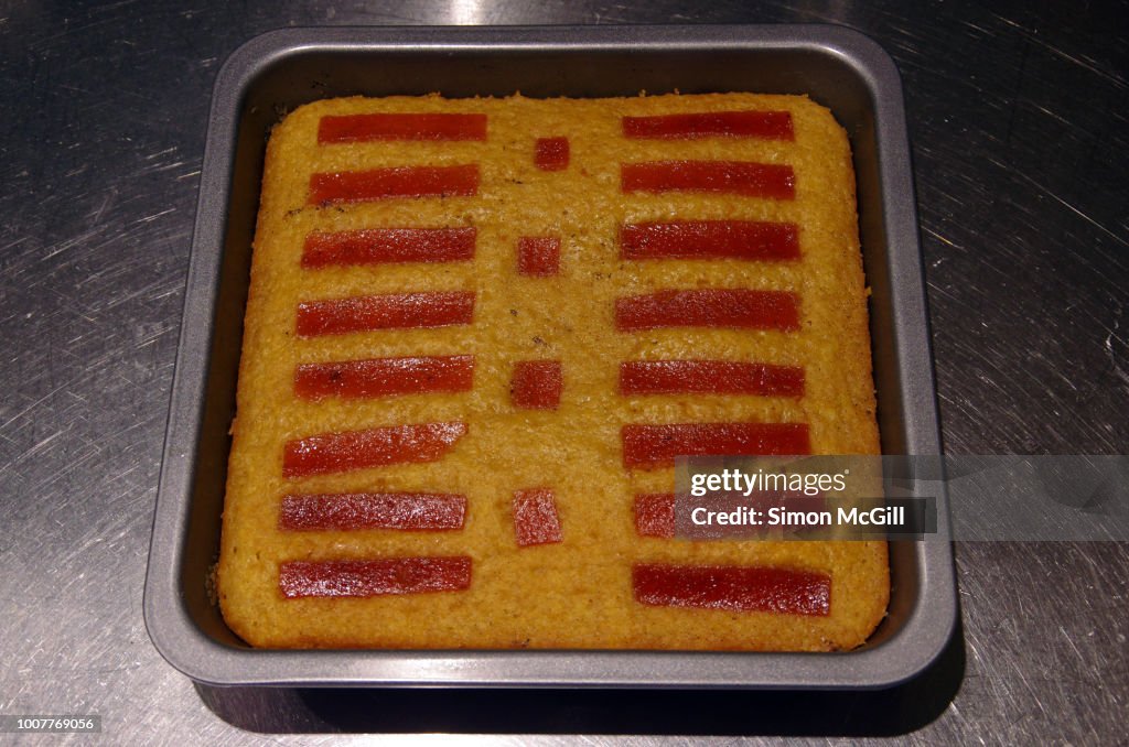 Quince paste cake in a baking pan on a stainless steel kitchen counter