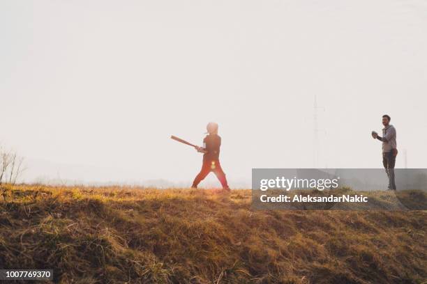 father with his son playing a game of softball on the field - playing catch stock pictures, royalty-free photos & images