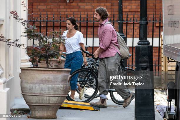 Boris Johnson's wife, Marina Wheeler, and son Milo assist as removal men take out belongings from the Foreign Secretary's grace-and-favour residence...