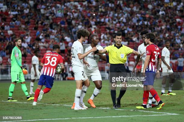 Yacine Adli of Paris Saint Germain and Roberto Olabe of Atletico Madrid are separated by the referee during the International Champions Cup match...