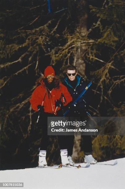 David Bowie is providing ski lessons to his wife Iman Bowie, Gstaad, 4th January 1993
