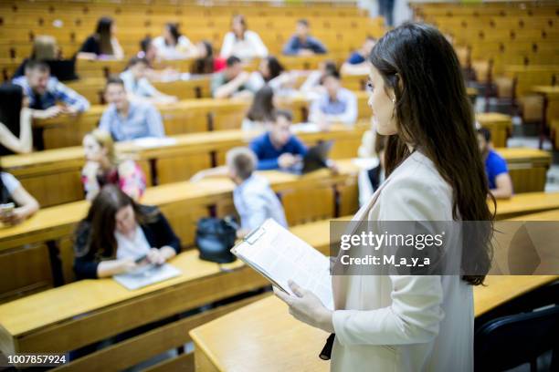 students sitting in amphitheater - teaching assistant stock pictures, royalty-free photos & images