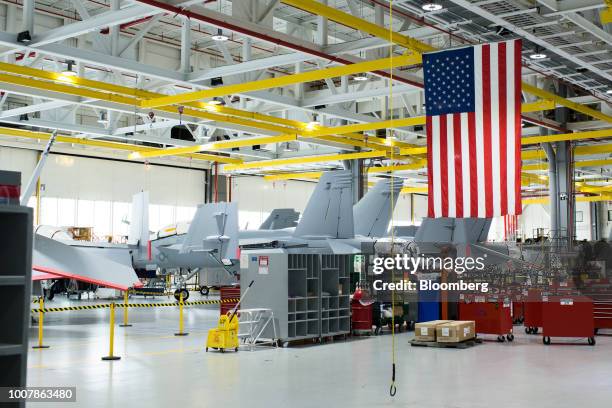 An American flag hangs near Boeing Co. F/A-18 Super Hornet fighter jets at the Boeing Defense, Space & Security facility in St. Louis, Missouri,...