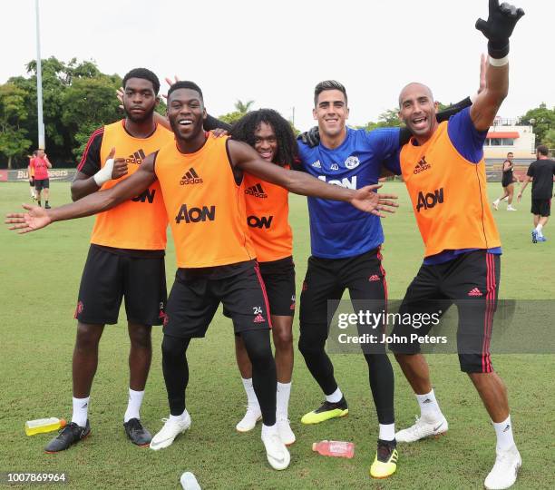 Ro-Shaun Williams, Timothy Fosu-Mensah, Tahith Chong, Joel Pereira and Lee Grant of Manchester United celebrate during a training session as part of...