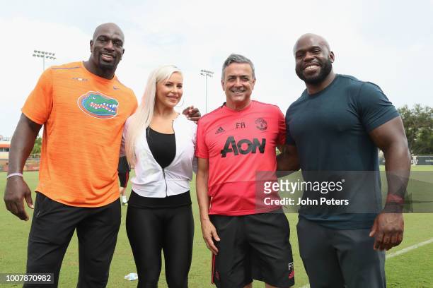 Coach Ricardo Formosinho of Manchester United pose with WWE wrestlers Apollo Crews, Dana Brooke and Titus O'Neil after a training session as part of...
