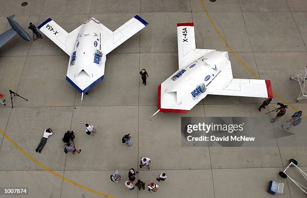 Two X-45A Unmanned Combat Air Vehicles are shown to members of the news media July 11, 2002 at Edwards Air Force Base, California. The X-45A,...