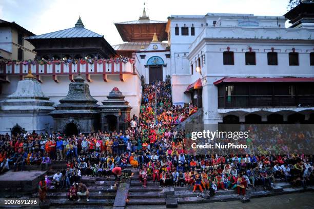 Nepalese devotees arrive to observe evening Aarti during Shrawan Sombar festival at the premises of Pashupatinath Temple, Kathmandu, Nepal on Monday,...