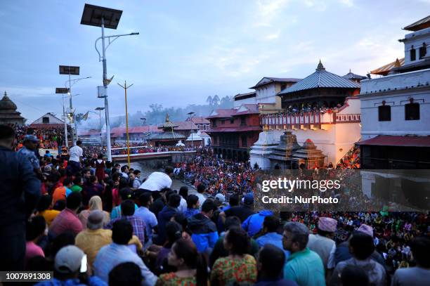 Nepalese devotees arrive to observe evening Aarti during Shrawan Sombar festival at the premises of Pashupatinath Temple, Kathmandu, Nepal on Monday,...