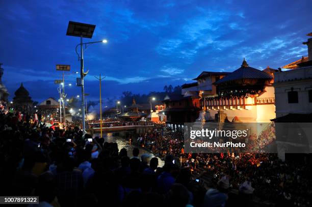 Nepalese devotees arrive to observe evening Aarti during Shrawan Sombar festival at the premises of Pashupatinath Temple, Kathmandu, Nepal on Monday,...