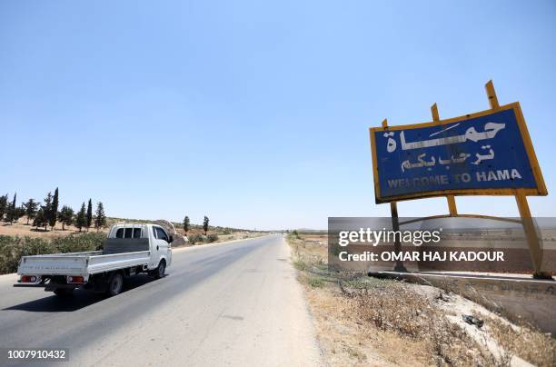 Vehicle loaded with merchandise enters the northwestern city of Hama on July 8, 2018. - Barrels of oil, sacks of sugar, crates piled with fruit:...