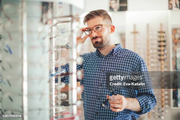 in the optics store - spectacles stock pictures, royalty-free photos & images
