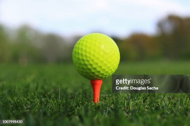 close-up of golf ball on a driving tee - golf tee stock pictures, royalty-free photos & images