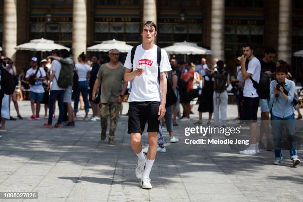 Model Jack Chambers wears a white Supreme t-shirt, black shorts, Nike socks, and Gucci sneakers after the Louis Vuitton show during Paris Fashion...