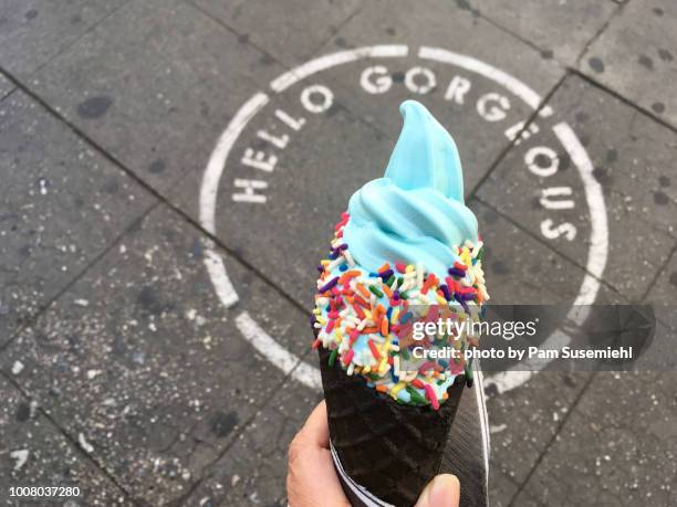 blue soft-serve ice cream in charcoal waffle cone - softeis stock-fotos und bilder