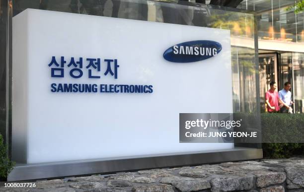 The logo of Samsung Electronics is seen outside the Samsung building in Seoul on July 31, 2018. - Samsung Electronics on July 31 reported a 0.1...