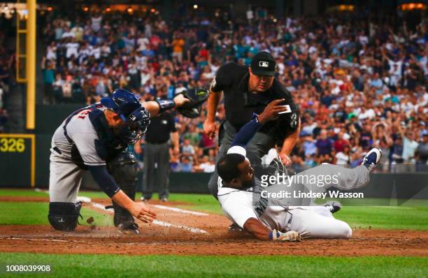 Denard Span of the Seattle Mariners sides into home safely against Max Stassi of the Houston Astros in the sixth inning at Safeco Field on July 30,...