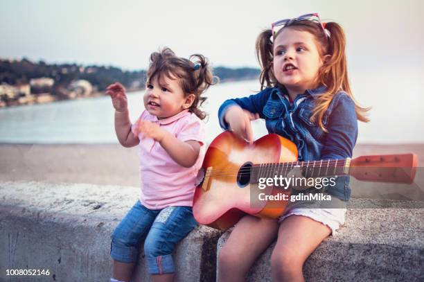 little children have fun on sunset tropical beach - tropical music stock pictures, royalty-free photos & images