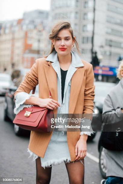 Model Vera Van Erp sports smeared light red lipstick after the Preen by Thornton Bregazzi show and wears a light brown blazer over a matching light...
