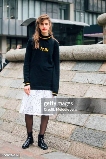 Model Veronica Manavella sports smeared light red lipstick after the Preen by Thornton Bregazzi show and wears a black "pain" swater, white...